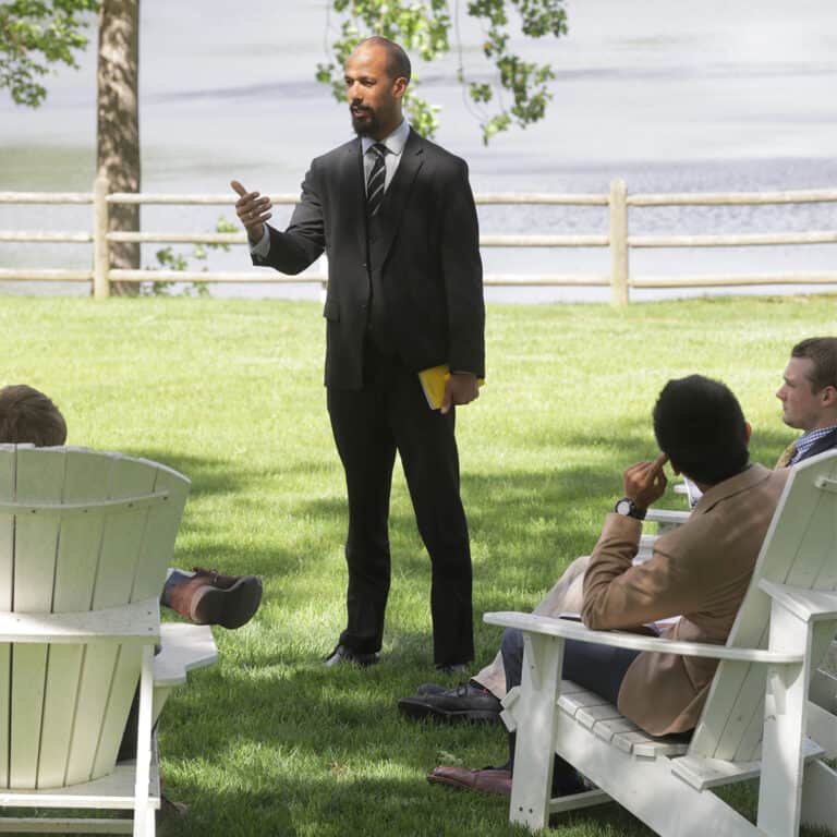 class meets on the lawn by the pond at boys boarding school in Virginia