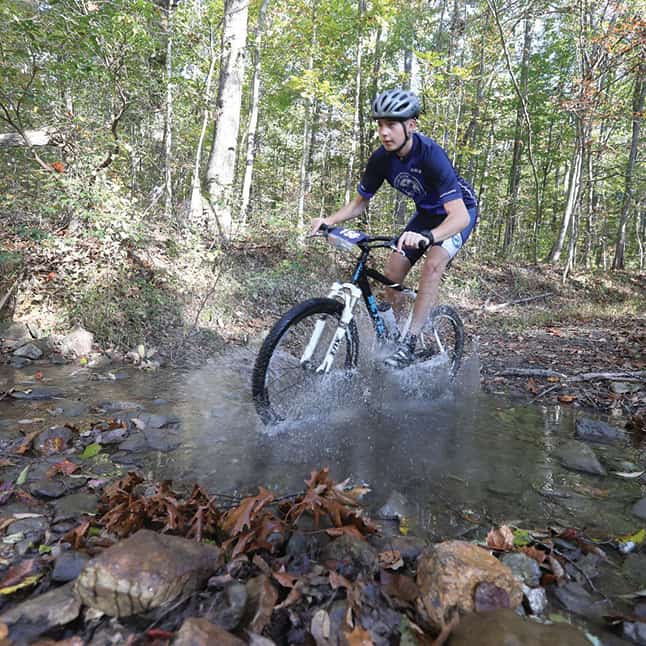 Mountain biking through a creek