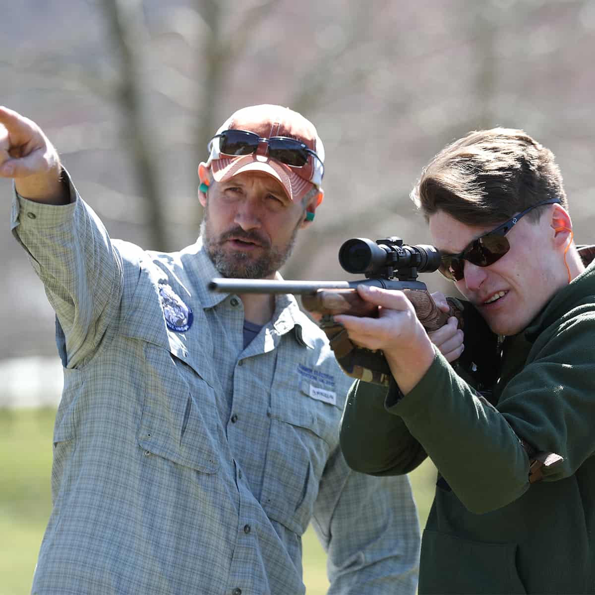 Outdoorsmen shooting rifles