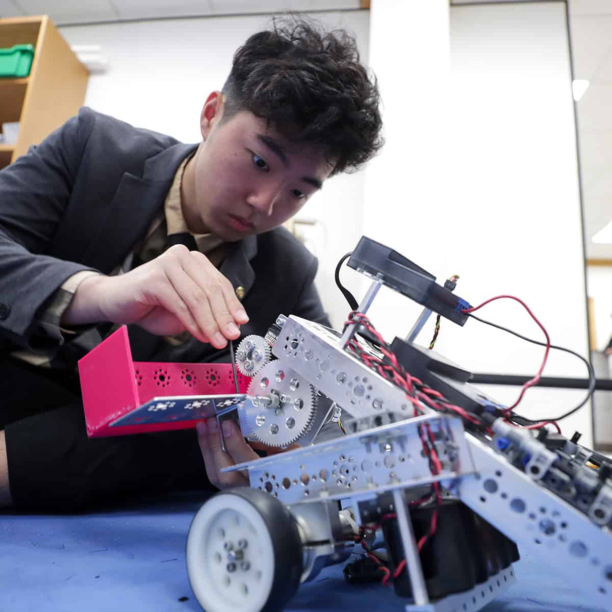 Student building a robot