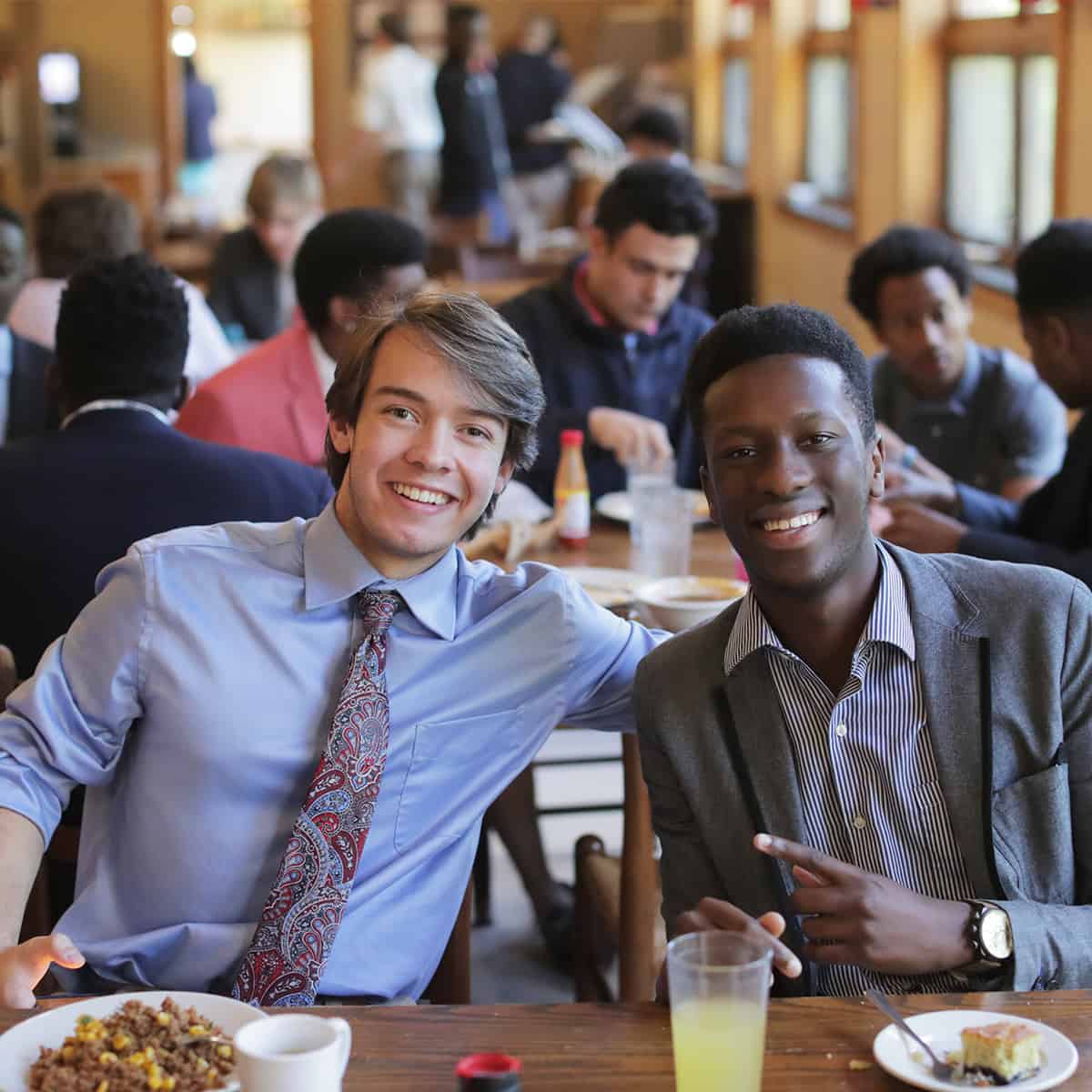 Students smiling in the dining hall.