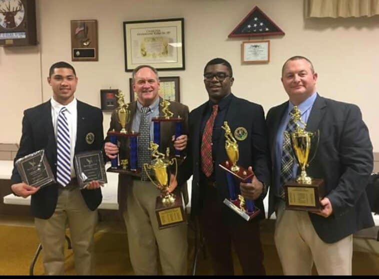 students with trophies