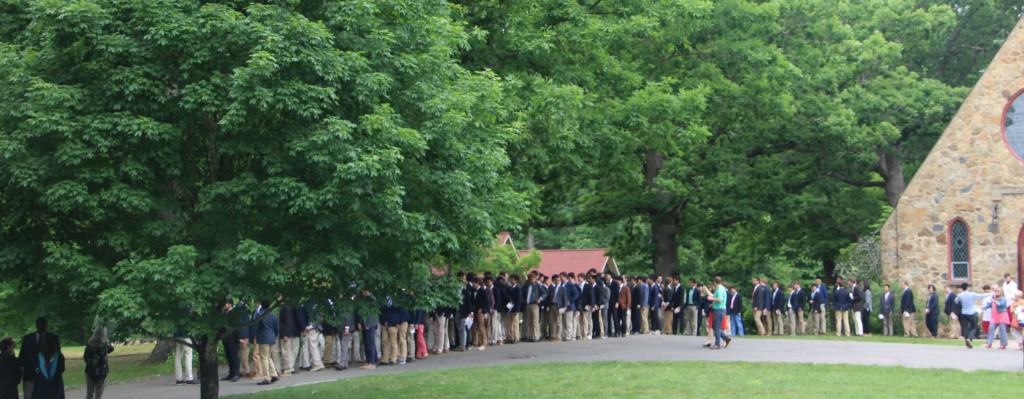 students and faculty outside the chapel